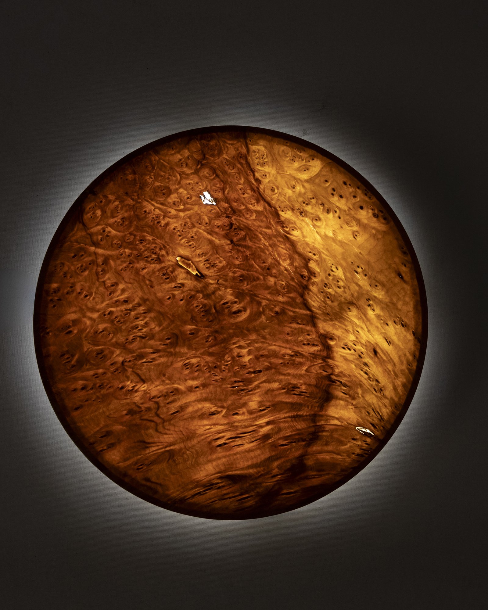 YÖ wall sconce made of laurel wood veneer with soft ambient lighting