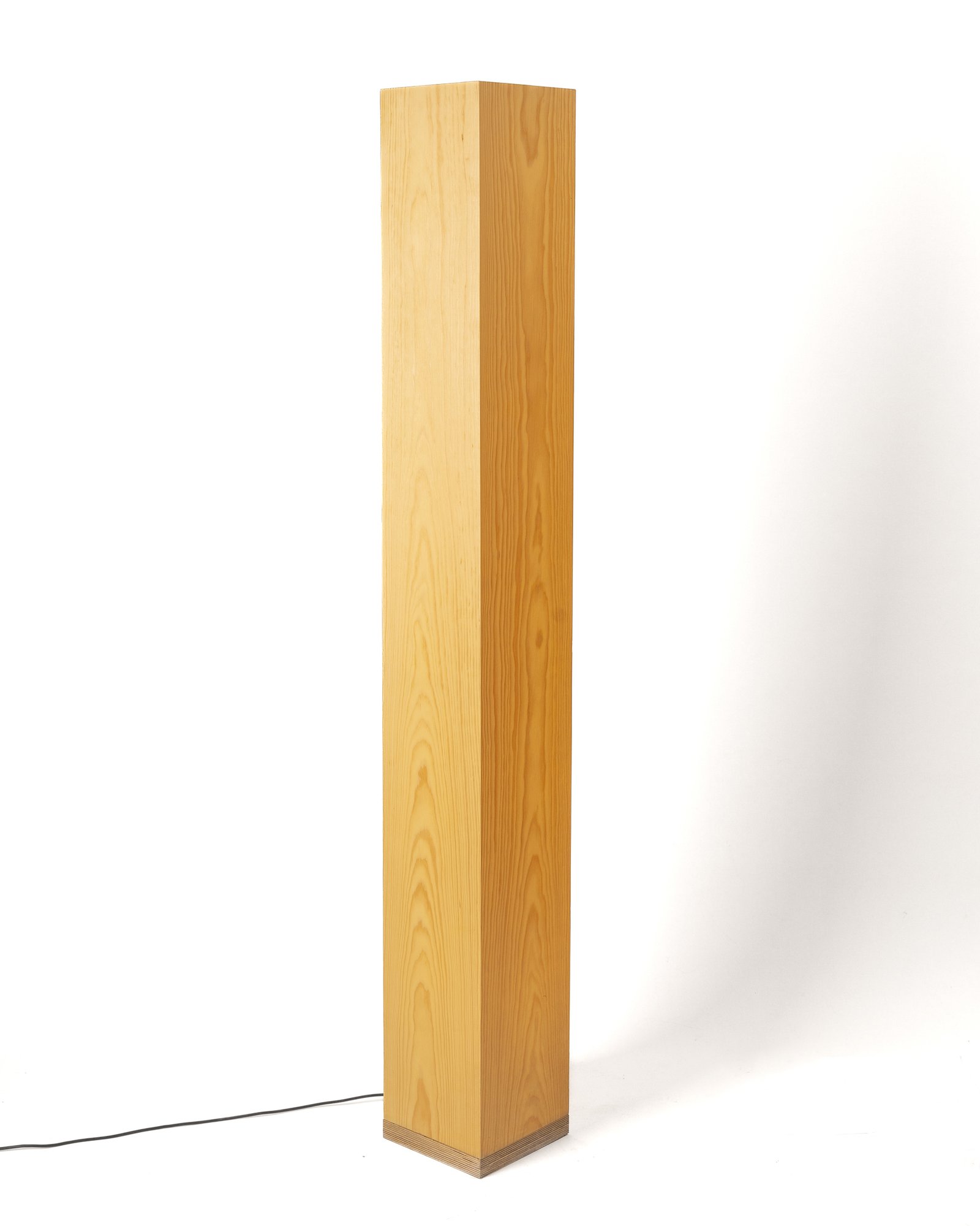 Pine wood floor lamp creating warm ambient lighting in living room